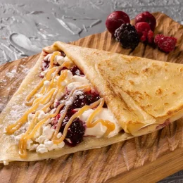 Pancake or crepe with cottage cheese and berries sweet sauce